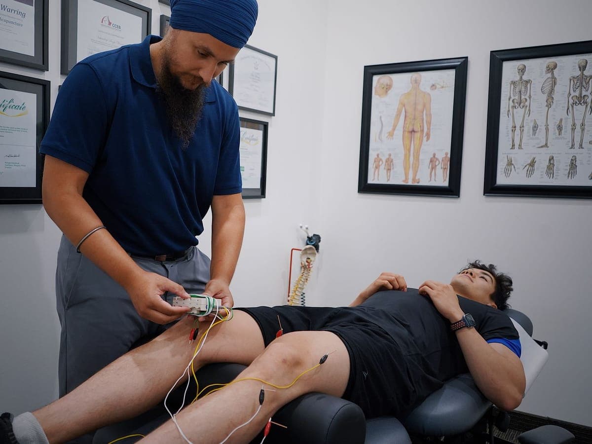 Physiotherapist giving electrotherapy for a patient's knee